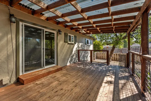 a view of a porch with wooden floor and iron stairs