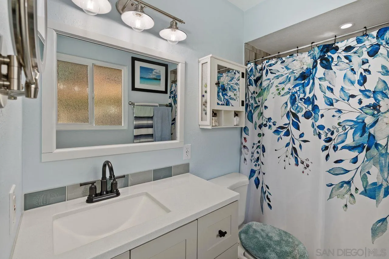 9545 Chestnut Street Spring Valley, CA 91977 - Photo 16 of 32 a bathroom with a sink and a mirror