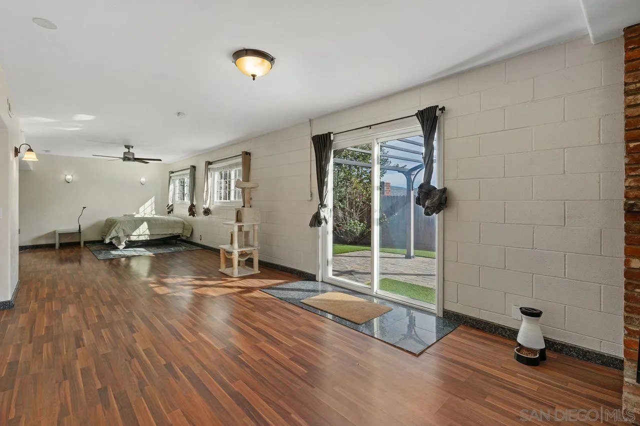 9545 Chestnut Street Spring Valley, CA 91977 - Photo 22 of 32 a view of empty room with wooden floor and windows