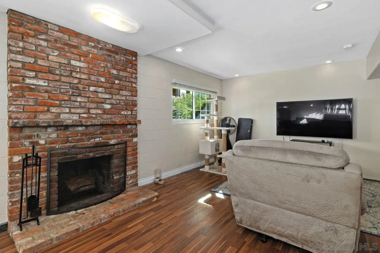 9545 Chestnut Street Spring Valley, CA 91977 - Photo 23 of 32 a living room with furniture and a fireplace