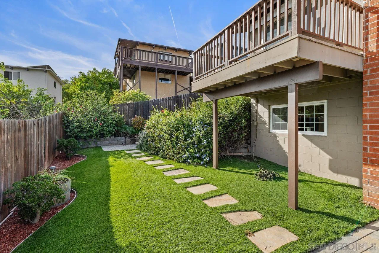 9545 Chestnut Street Spring Valley, CA 91977 - Photo 29 of 32 a backyard of a house with plants and large trees