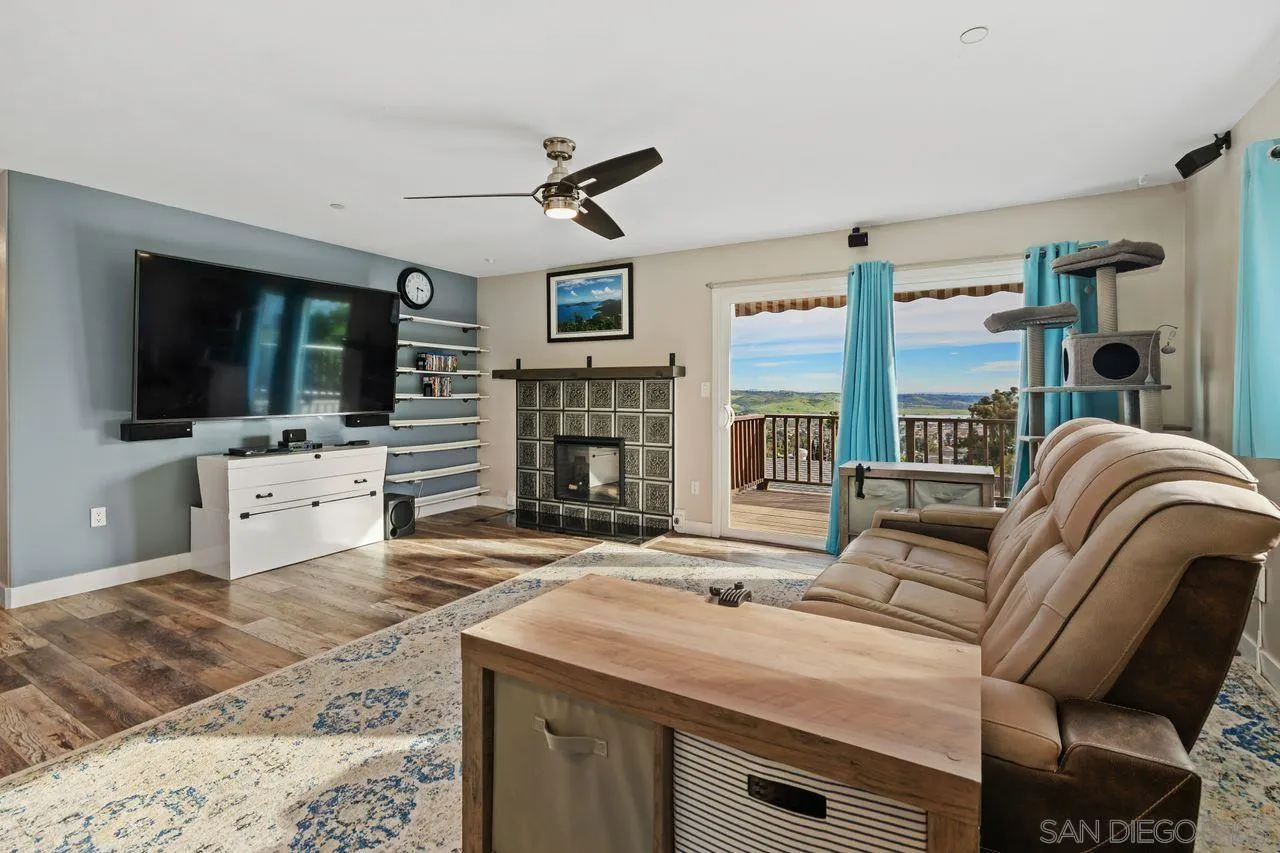 9545 Chestnut Street Spring Valley, CA 91977 - Photo 6 of 32 a living room with fireplace furniture and a flat screen tv