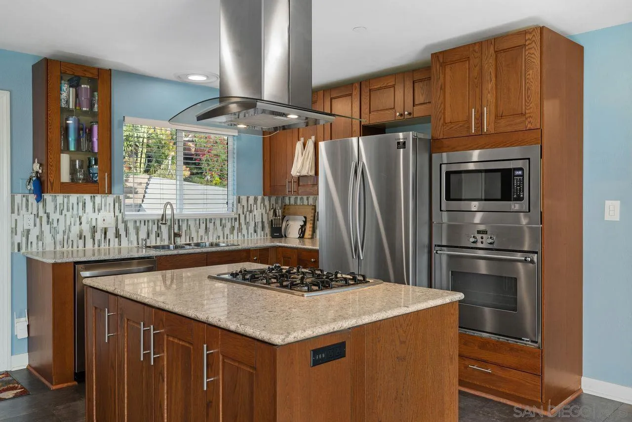 9545 Chestnut Street Spring Valley, CA 91977 - Photo 9 of 32 a kitchen with stainless steel appliances a stove a refrigerator and a sink