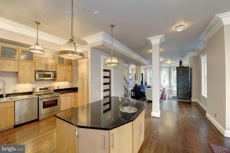 1219 Q Street Northwest Washington, DC 20009 - Photo 11 of 25 a kitchen with stainless steel appliances granite countertop a sink a stove and refrigerator