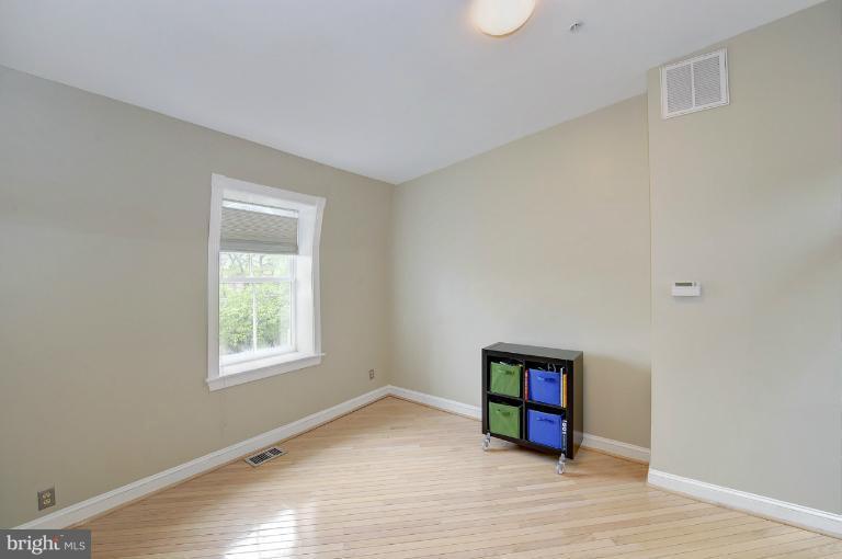 1219 Q Street Northwest Washington, DC 20009 - Photo 13 of 25 an empty room with wooden floor and windows