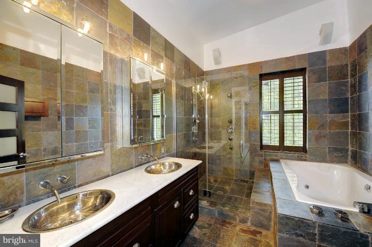 1219 Q Street Northwest Washington, DC 20009 - Photo 17 of 25 a bathroom with a tub sink and mirror