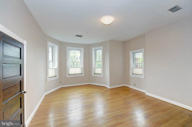 1219 Q Street Northwest Washington, DC 20009 - Photo 3 of 25 a view of empty room with wooden floor and fan