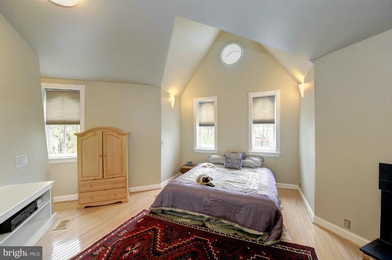 1219 Q Street Northwest Washington, DC 20009 - Photo 21 of 25 a bedroom with a bed and wooden floor