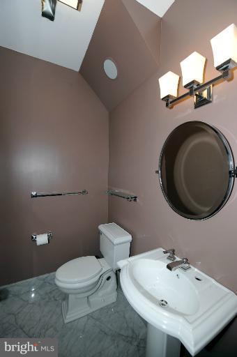 1219 Q Street Northwest Washington, DC 20009 - Photo 22 of 25 a bathroom with a sink a toilet and mirror