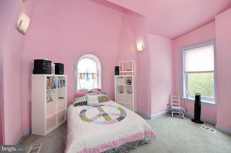 1219 Q Street Northwest Washington, DC 20009 - Photo 24 of 25 a bedroom with a bed a chandelier and dresser