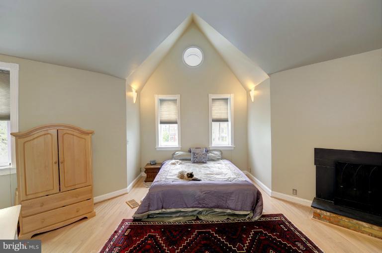1219 Q Street Northwest Washington, DC 20009 - Photo 7 of 25 a bedroom with a bed and wooden floor
