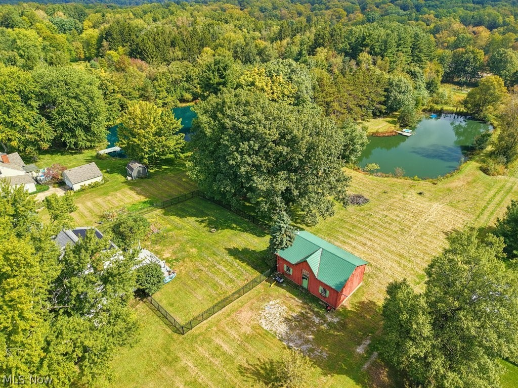 149 North Medina Line Road Akron, OH 44333 - Photo 37 of 42 Expansive property featuring a red outbuilding with a green roof, two distinct bodies of water, and mature trees