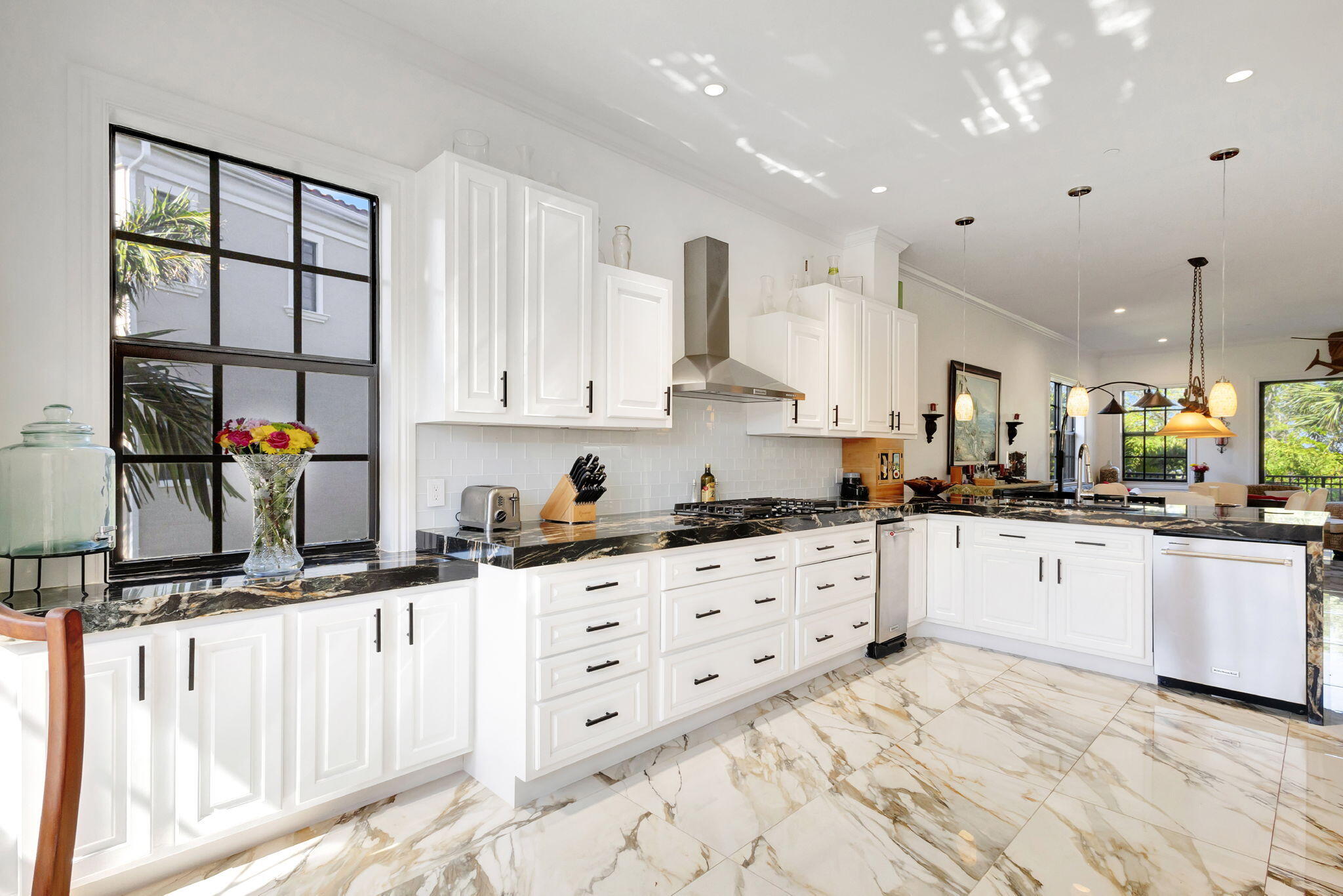 301 Del Sol Circle Tequesta, FL 33469 - Photo 17 of 83 a kitchen with granite countertop a white stove top oven sink and cabinets