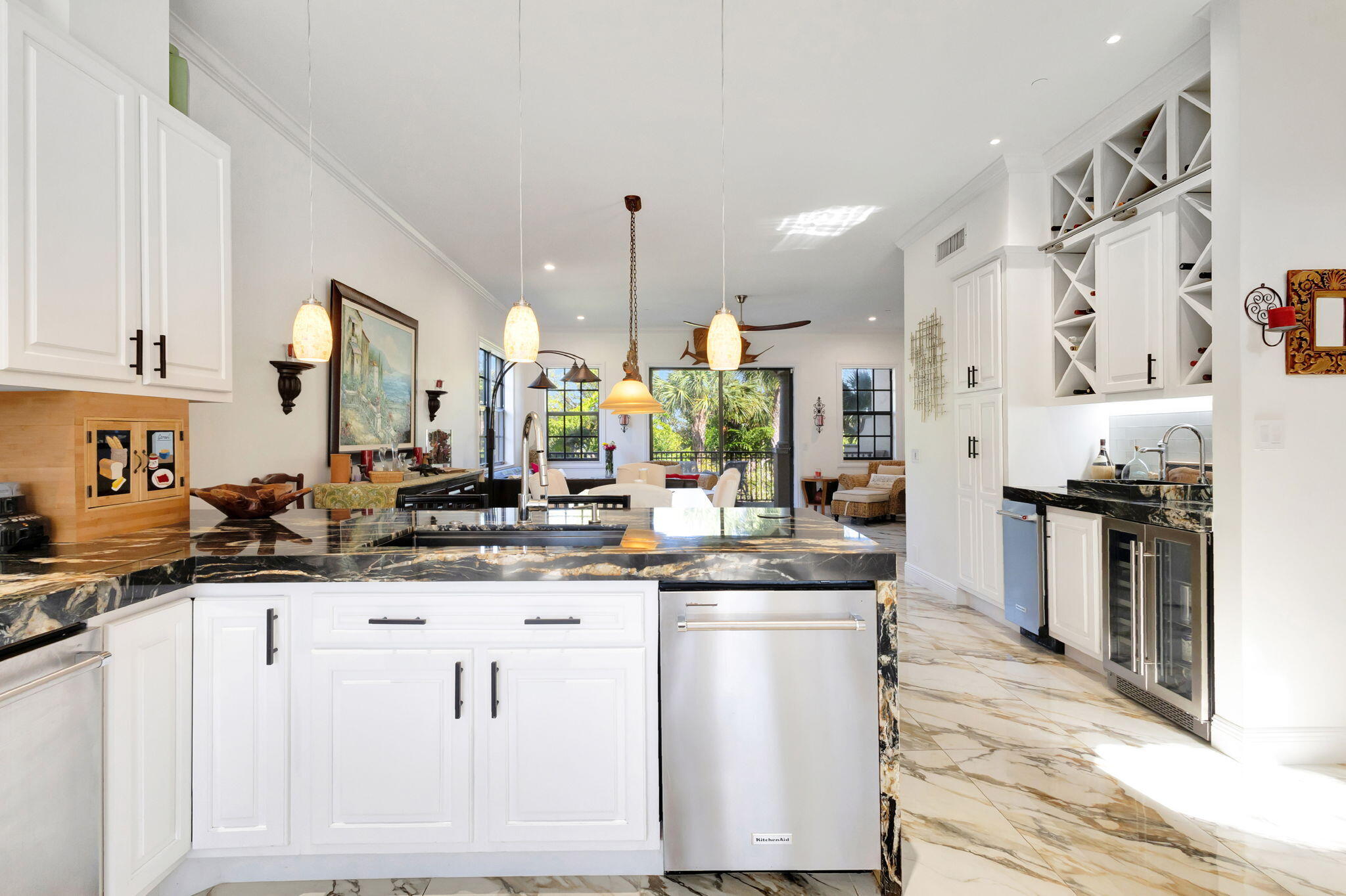 301 Del Sol Circle Tequesta, FL 33469 - Photo 18 of 83 a kitchen with stainless steel appliances kitchen island granite countertop a sink and cabinets