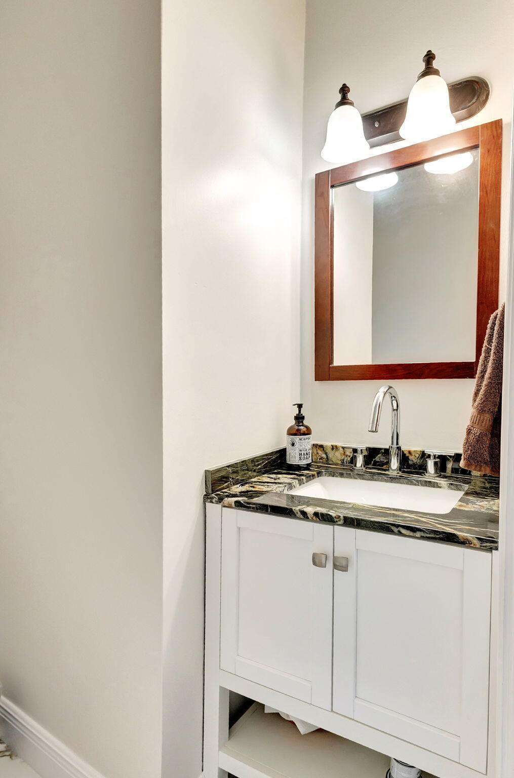 301 Del Sol Circle Tequesta, FL 33469 - Photo 29 of 83 a bathroom with a granite countertop sink and a mirror