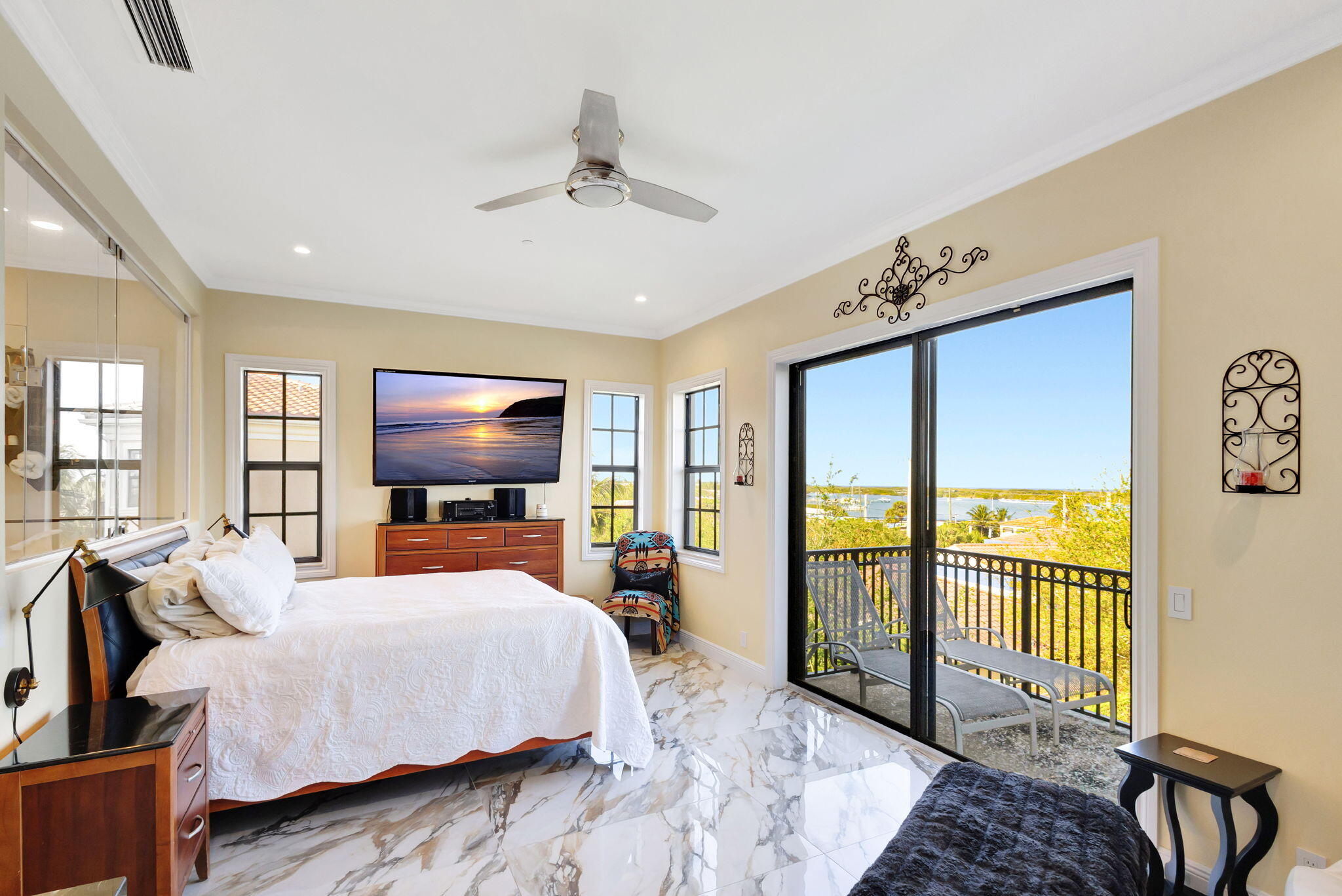 301 Del Sol Circle Tequesta, FL 33469 - Photo 32 of 83 a bedroom with a large bed and a flat tv screen