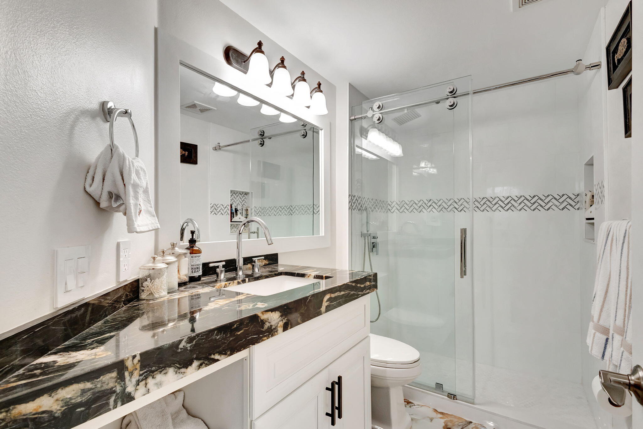 301 Del Sol Circle Tequesta, FL 33469 - Photo 45 of 83 a bathroom with a sink a toilet a mirror and shower