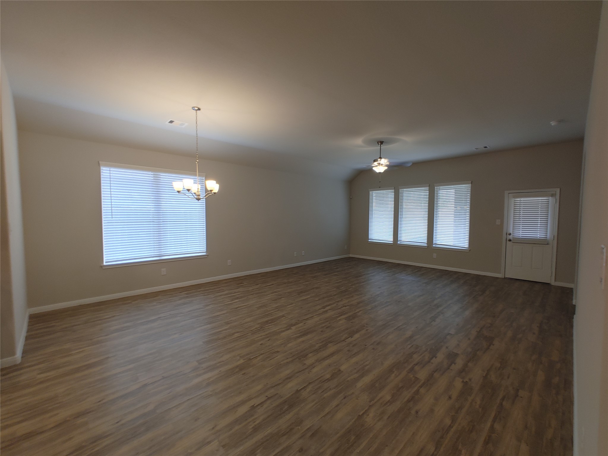 6206 Blue Coast Lane Conroe, TX 77304 - Photo 12 of 43 an empty room with wooden floor and windows