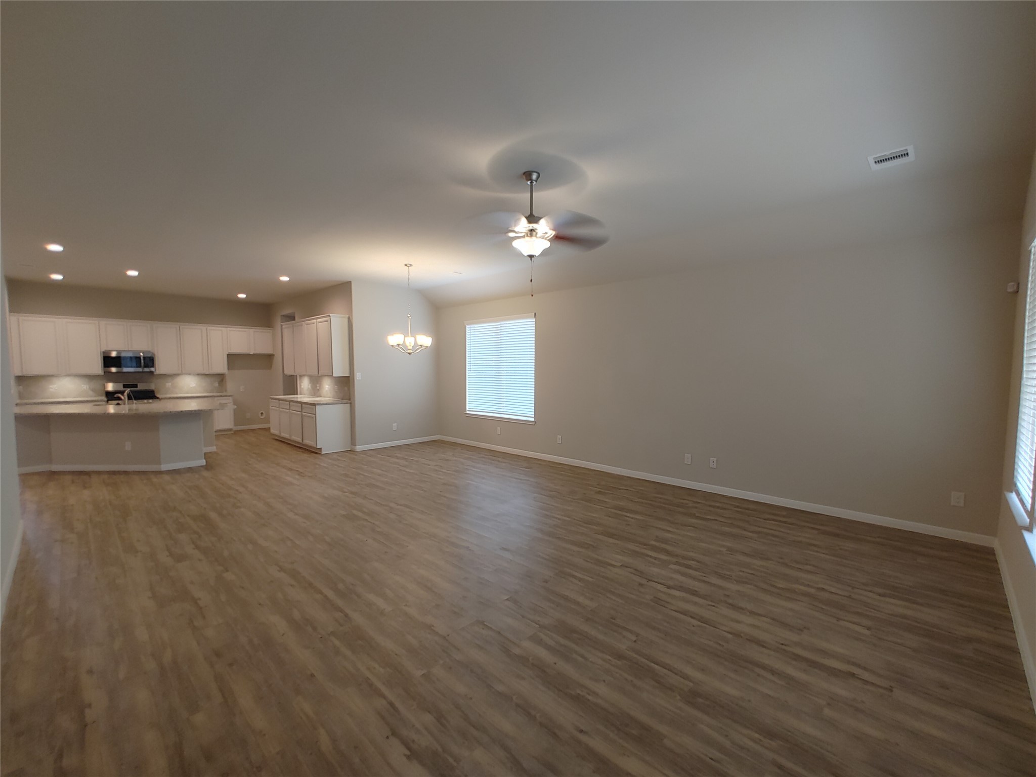 6206 Blue Coast Lane Conroe, TX 77304 - Photo 13 of 43 a view of a kitchen with a sink and a refrigerator