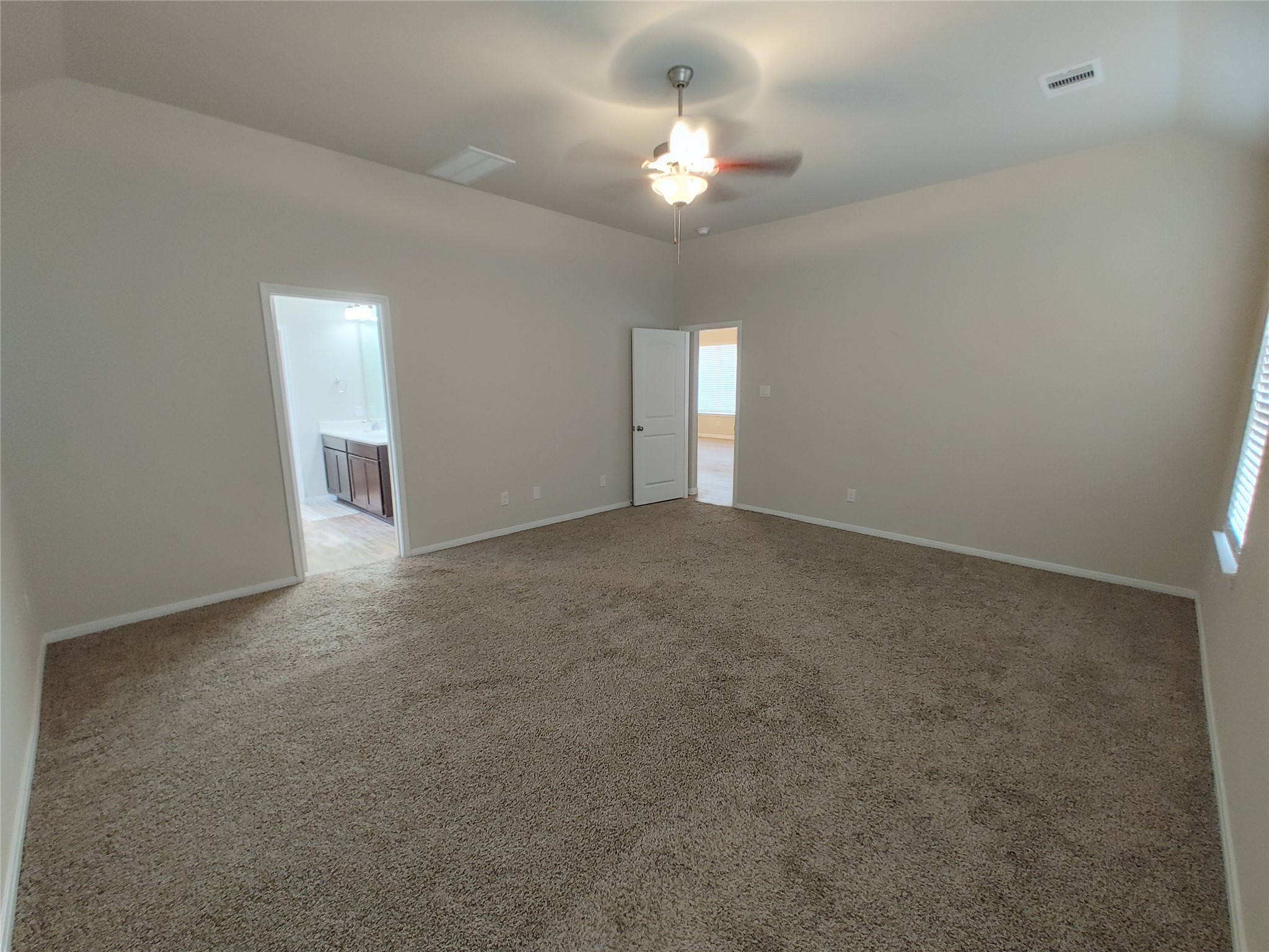 6206 Blue Coast Lane Conroe, TX 77304 - Photo 16 of 43 a view of an empty room with a chandelier fan