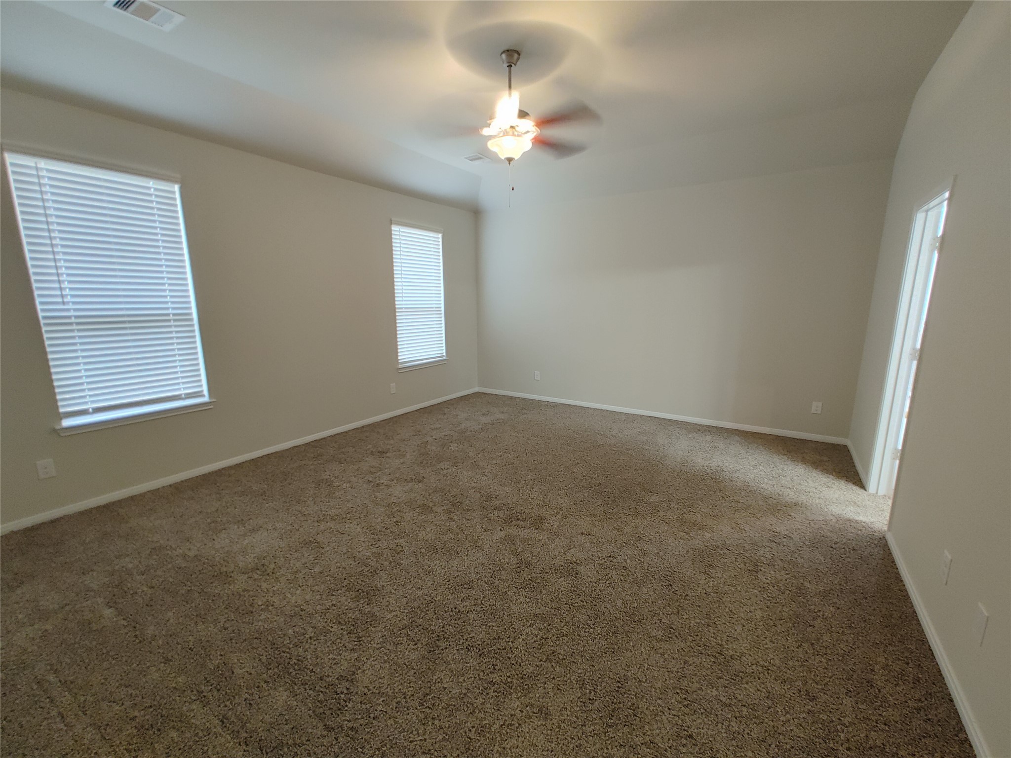 6206 Blue Coast Lane Conroe, TX 77304 - Photo 19 of 43 an empty room with windows and fan