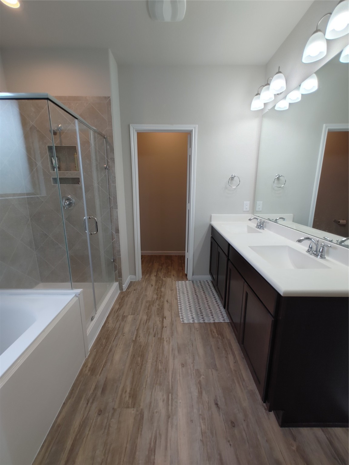 6206 Blue Coast Lane Conroe, TX 77304 - Photo 25 of 43 a bathroom with a sink a large mirror and a bathtub