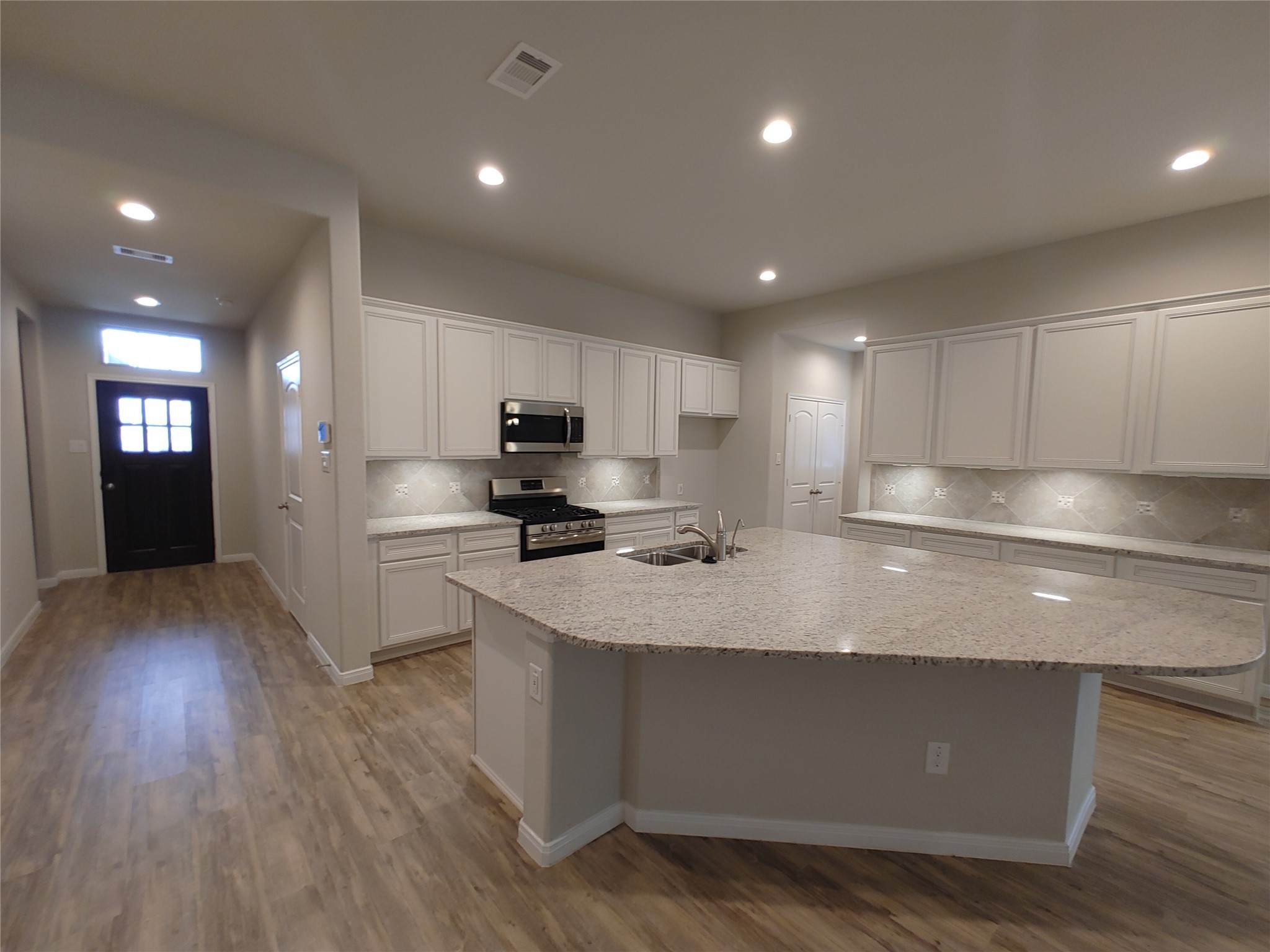6206 Blue Coast Lane Conroe, TX 77304 - Photo 4 of 43 a large kitchen with stainless steel appliances lots of counter space sink refrigerator and cabinets
