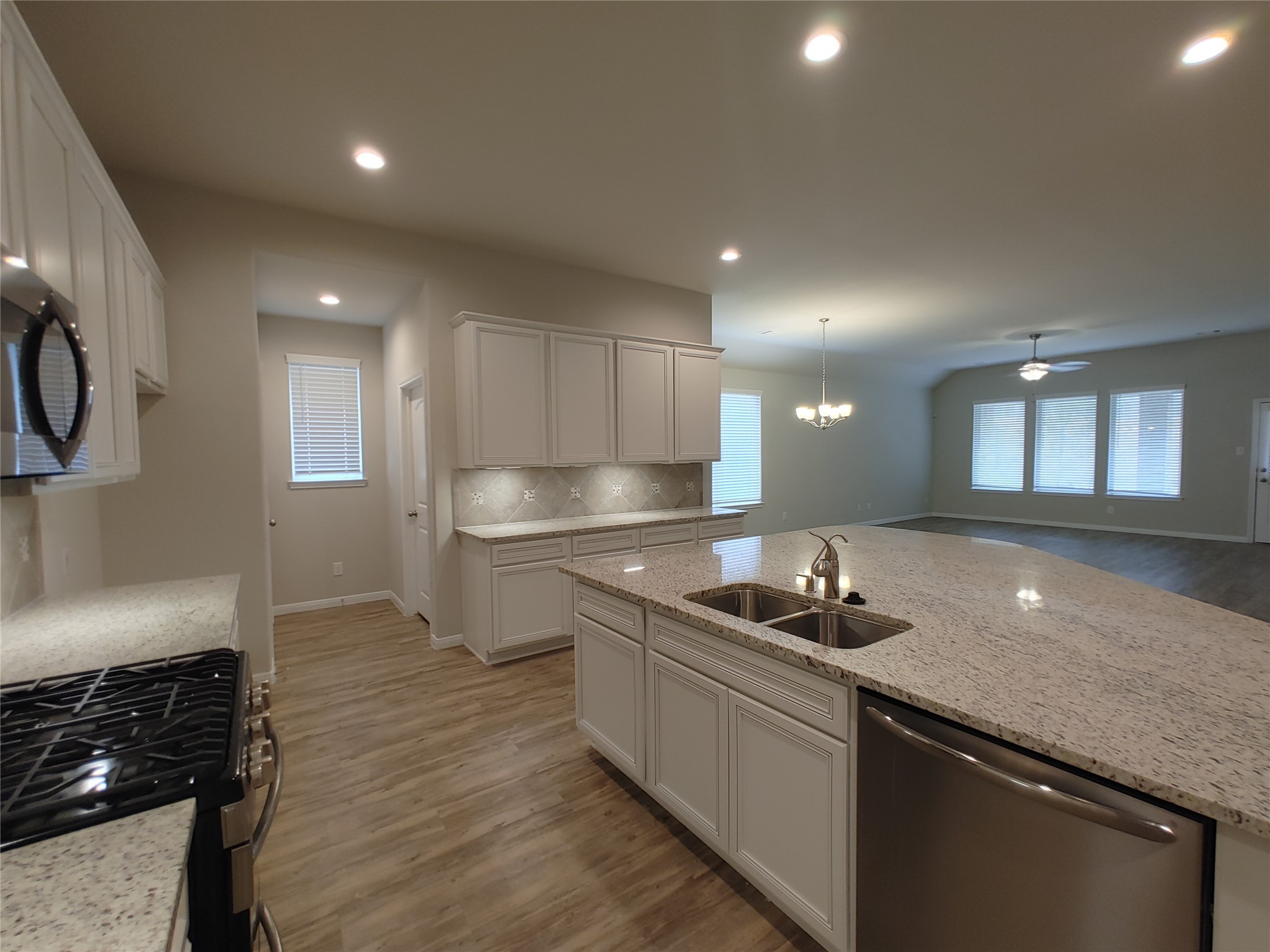 6206 Blue Coast Lane Conroe, TX 77304 - Photo 6 of 43 a kitchen with a sink and cabinets