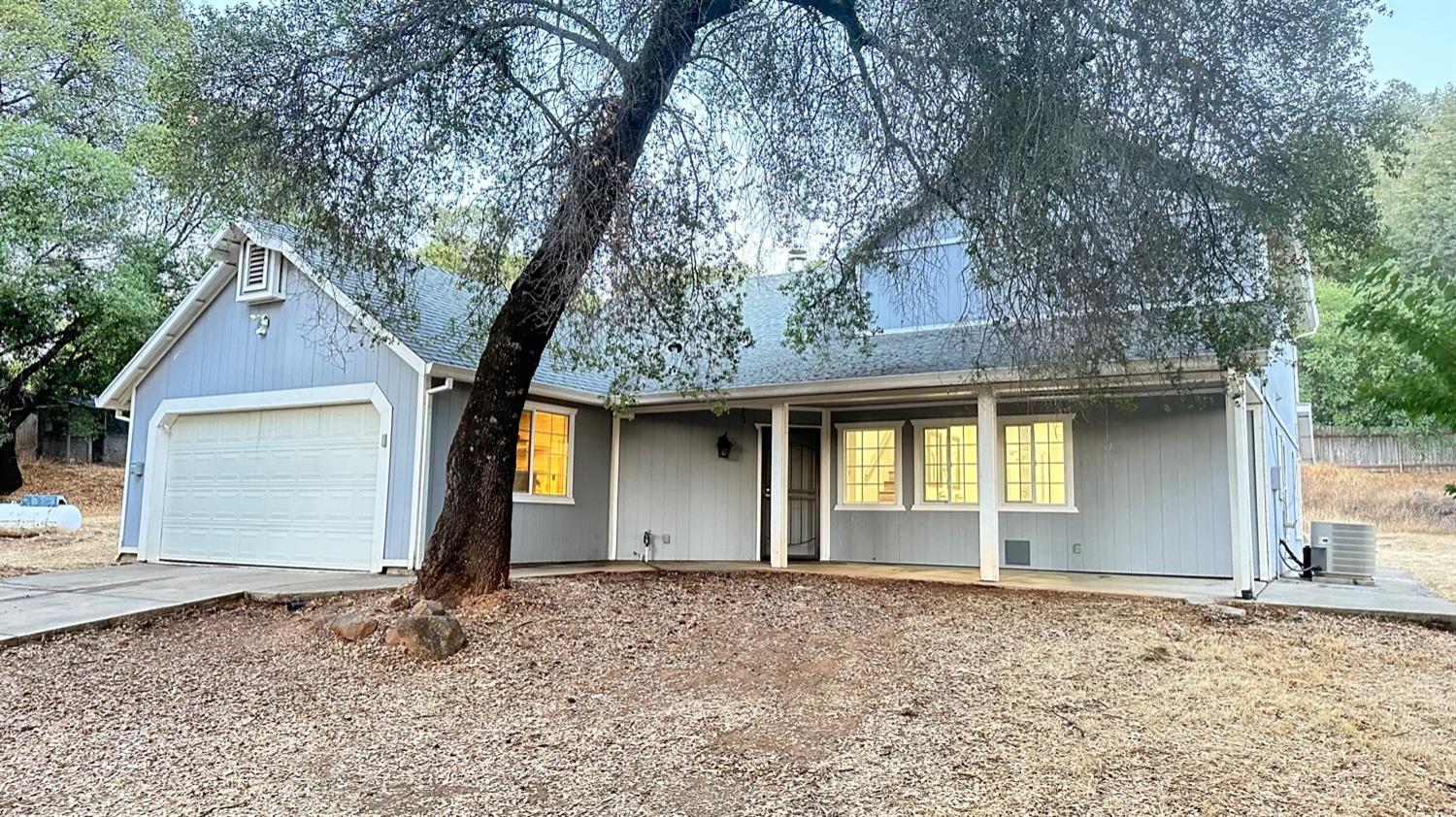16158 Vierra Road Rackerby, CA 95972 - Photo 1 of 1 a front view of a house with a yard and garage