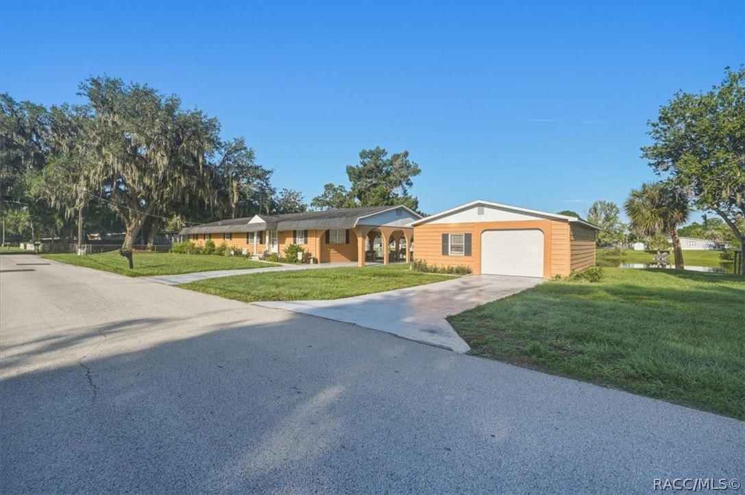 928 South Shad Terrace Inverness, FL 34450 - Photo 29 of 48 a front view of a house with a yard