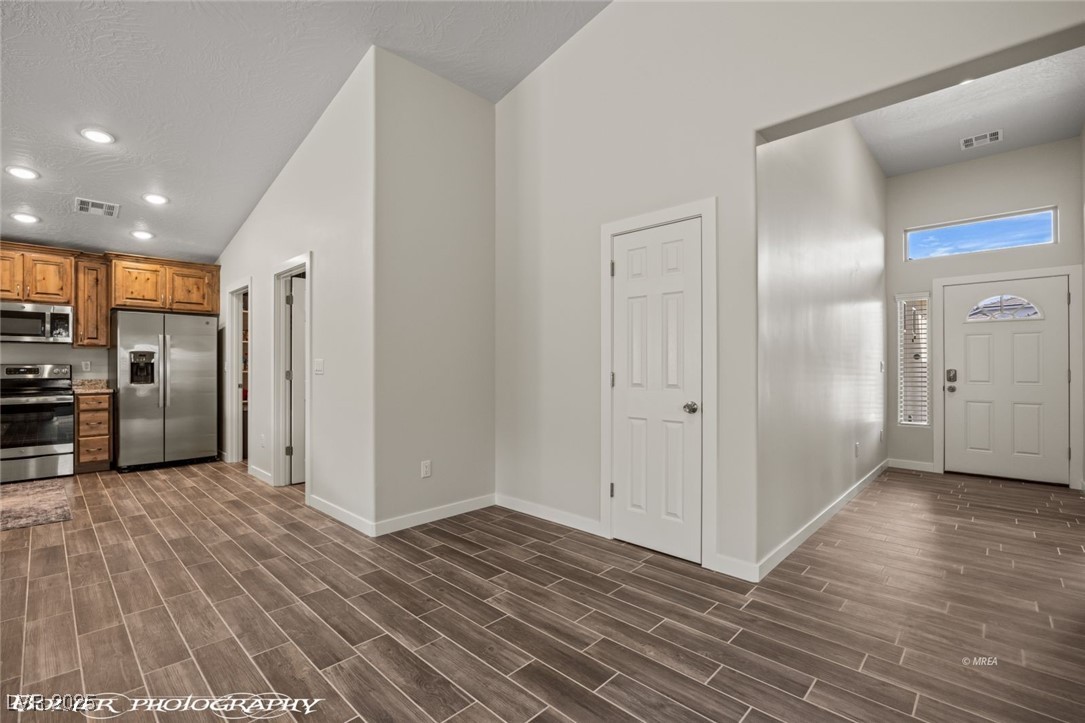 942 Shadow Hawk Ridge Mesquite, NV 89027 - Photo 42 of 67 Entryway featuring baseboards, recessed lighting, and dark wood-style flooring