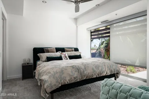 a bedroom with double bed and a window