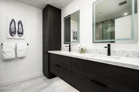 a bathroom with a double vanity sink and a mirror