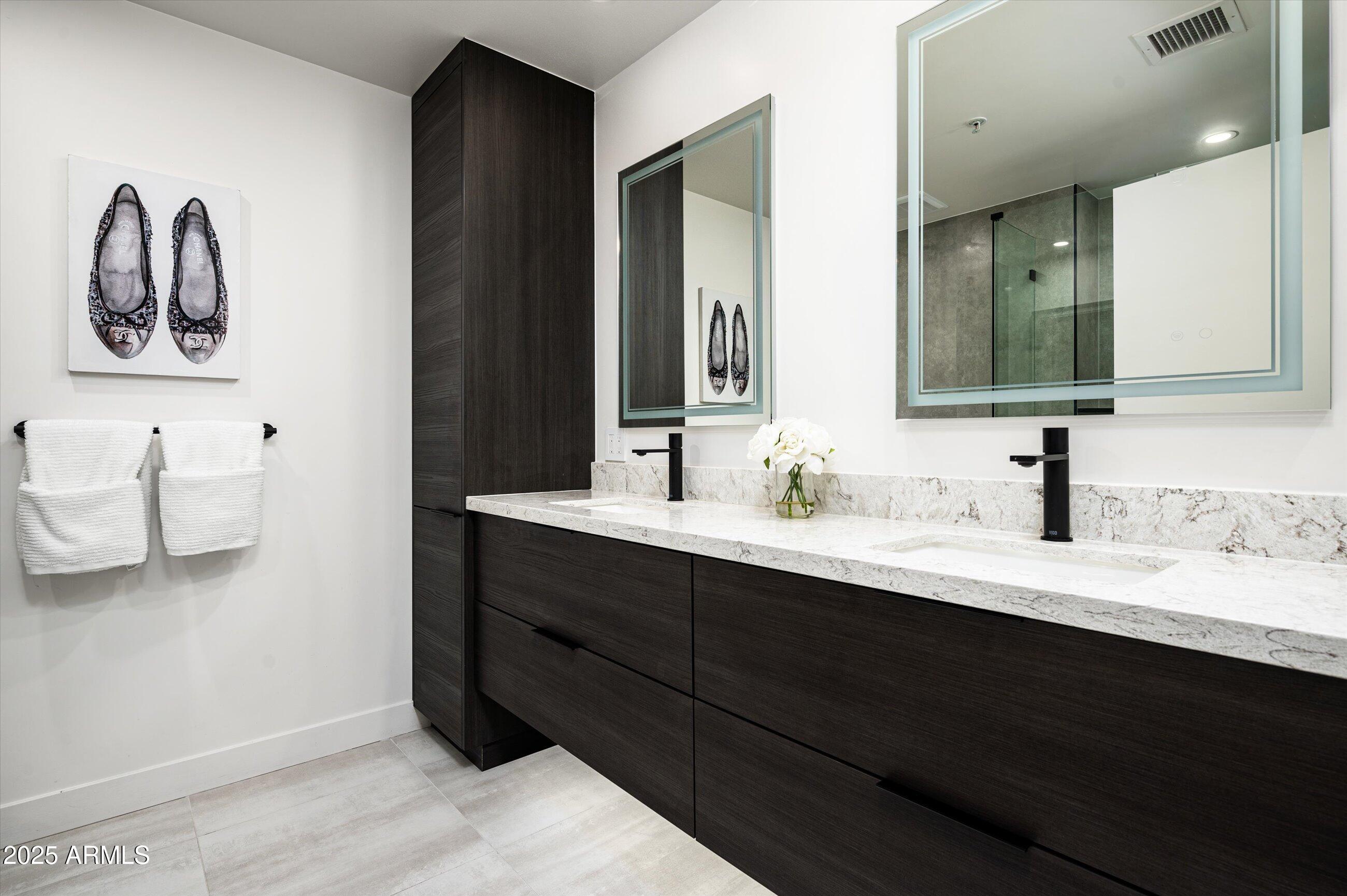 7167 East Rancho Vista Drive, Unit 4010 Scottsdale, AZ 85251 - Photo 12 of 43 a bathroom with a double vanity sink and a mirror