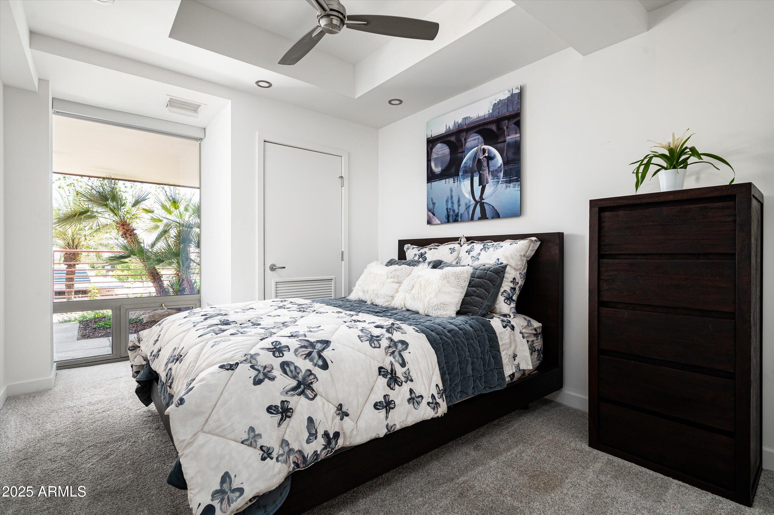 7167 East Rancho Vista Drive, Unit 4010 Scottsdale, AZ 85251 - Photo 15 of 43 a bedroom with a bed and a window
