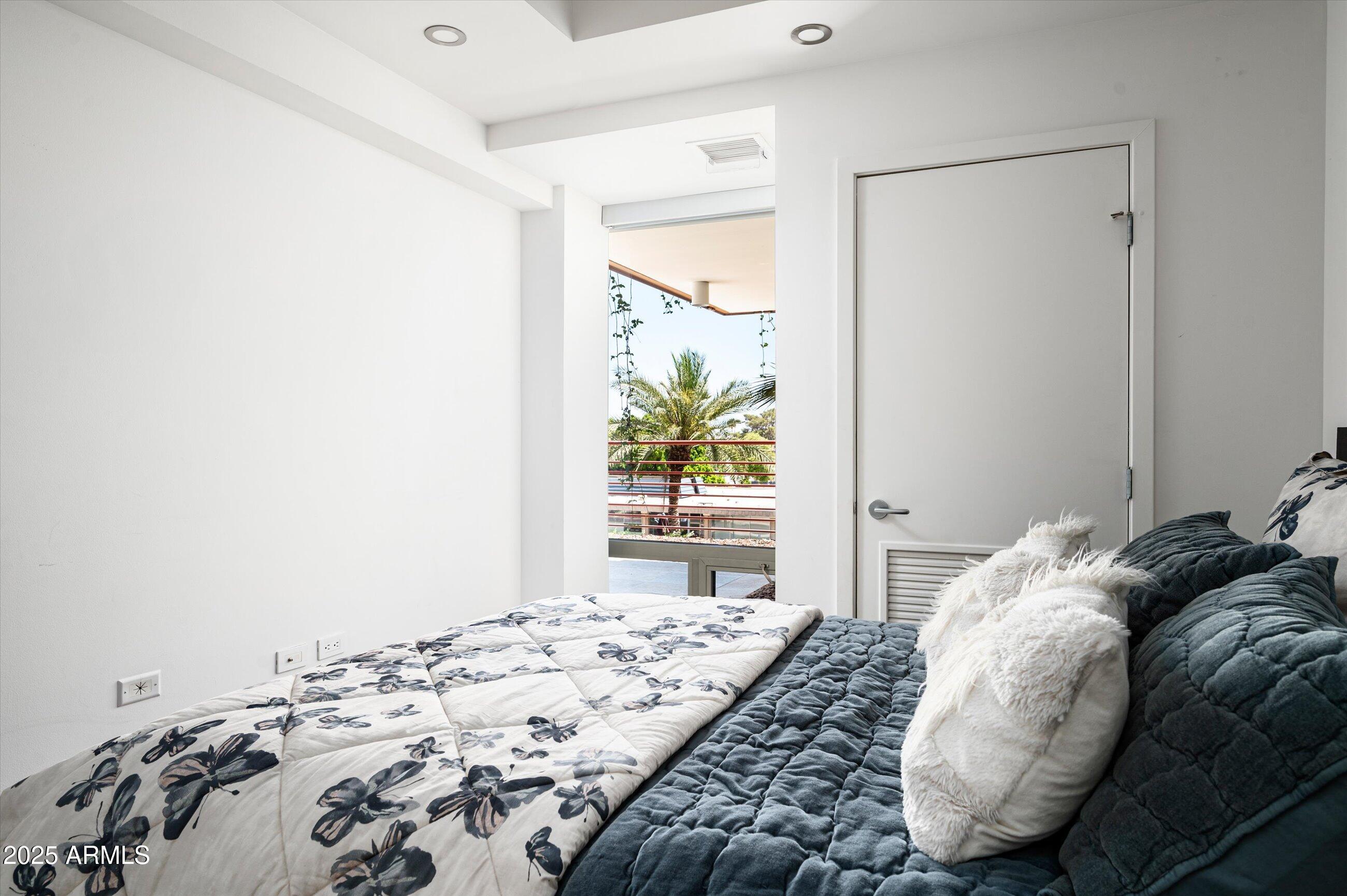 7167 East Rancho Vista Drive, Unit 4010 Scottsdale, AZ 85251 - Photo 16 of 43 a bedroom with a bed and a window