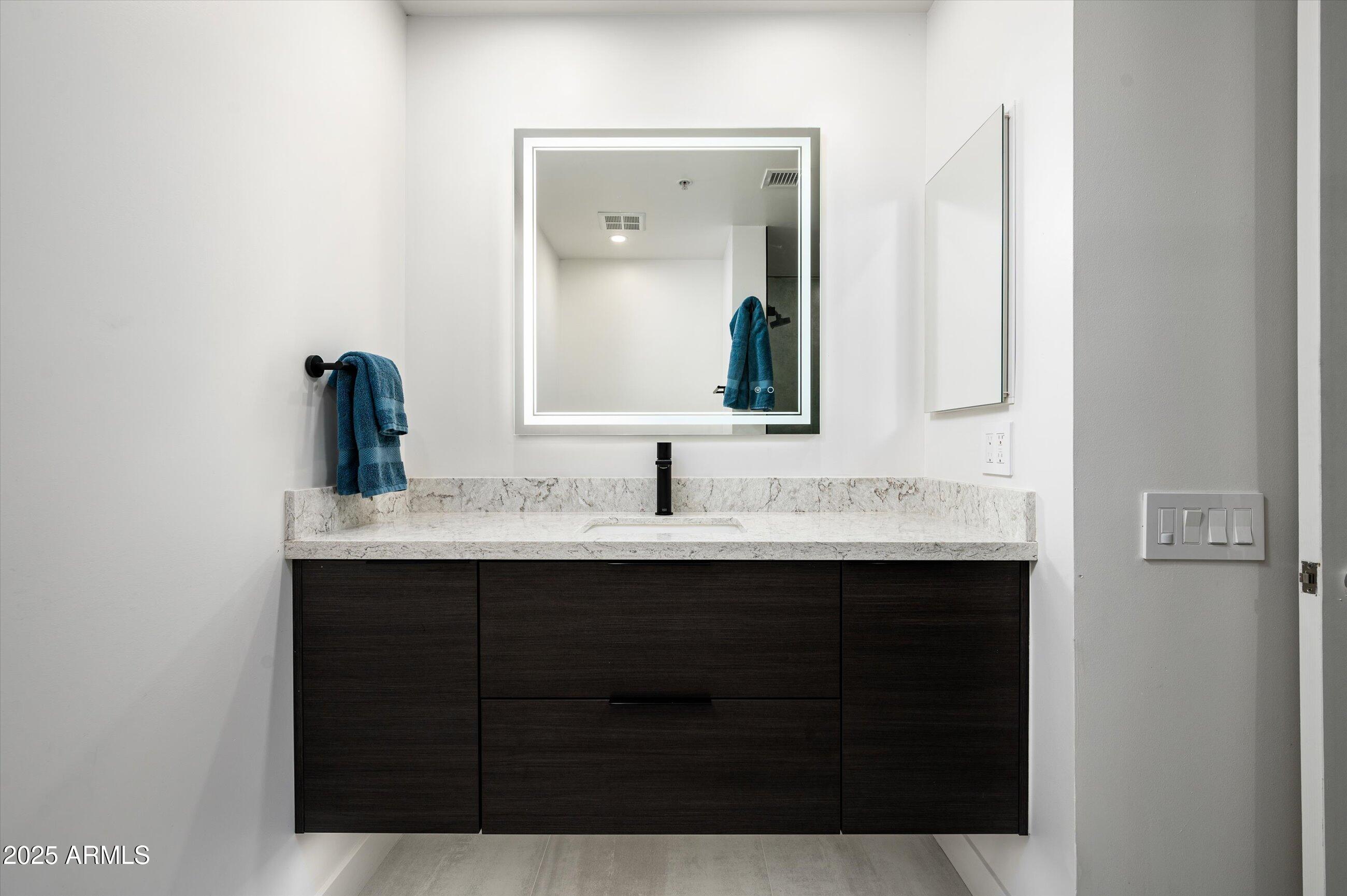7167 East Rancho Vista Drive, Unit 4010 Scottsdale, AZ 85251 - Photo 17 of 43 a bathroom with a sink and a mirror