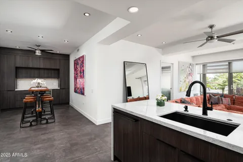 a kitchen with a sink appliances and a dining table