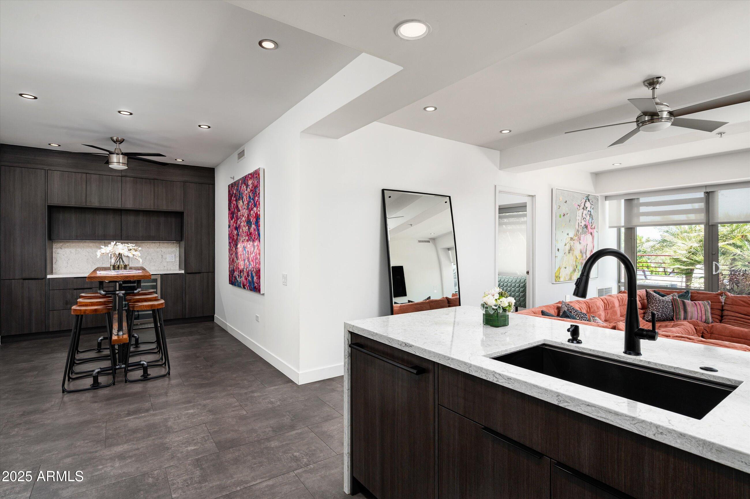 7167 East Rancho Vista Drive, Unit 4010 Scottsdale, AZ 85251 - Photo 2 of 43 a kitchen with a sink appliances and a dining table