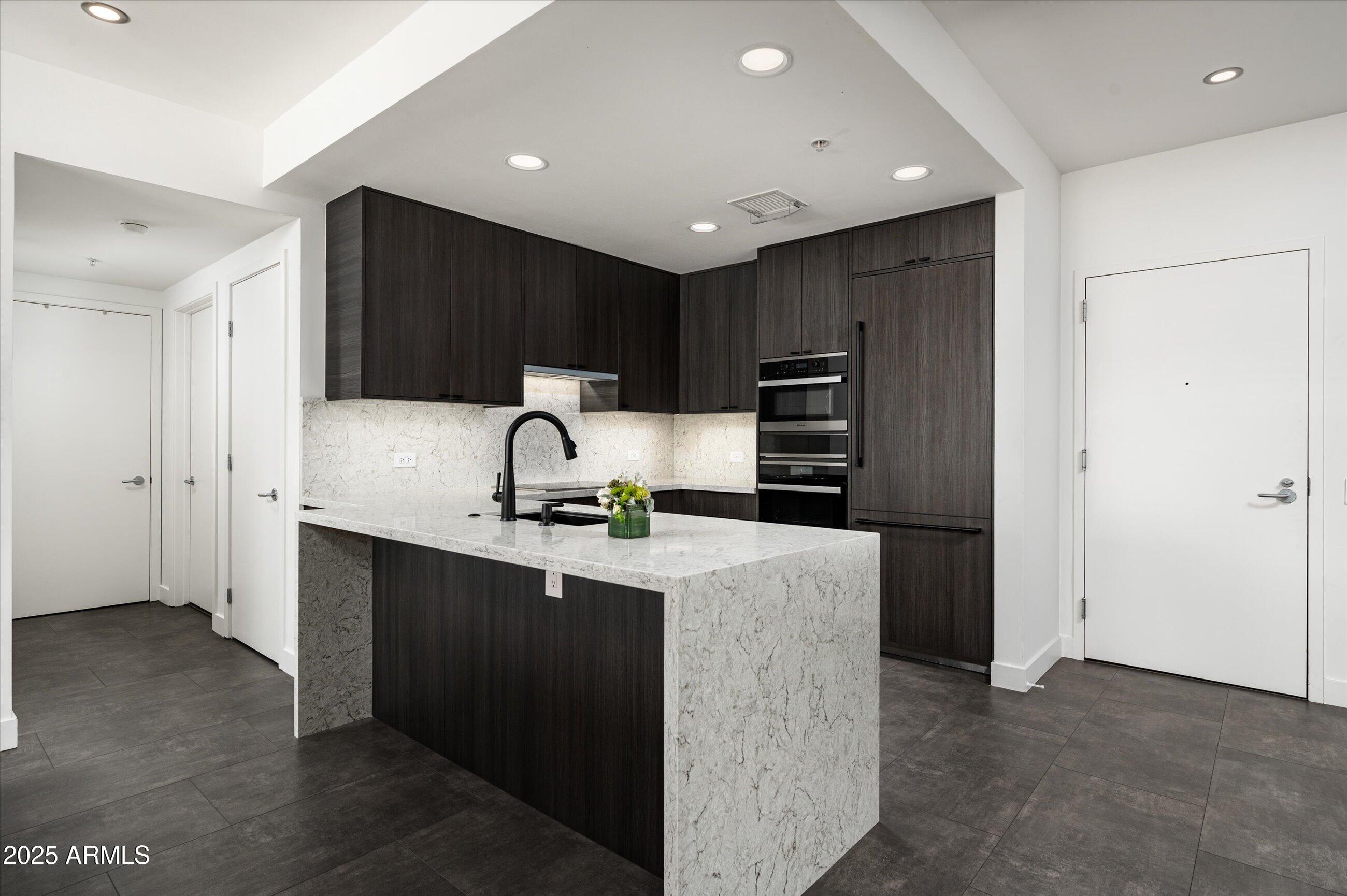 7167 East Rancho Vista Drive, Unit 4010 Scottsdale, AZ 85251 - Photo 3 of 43 a kitchen with kitchen island a sink stainless steel appliances and cabinets