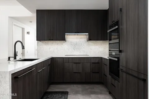a kitchen with stainless steel appliances granite countertop a refrigerator and a sink