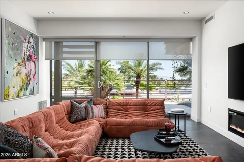 a living room with furniture a rug and a window
