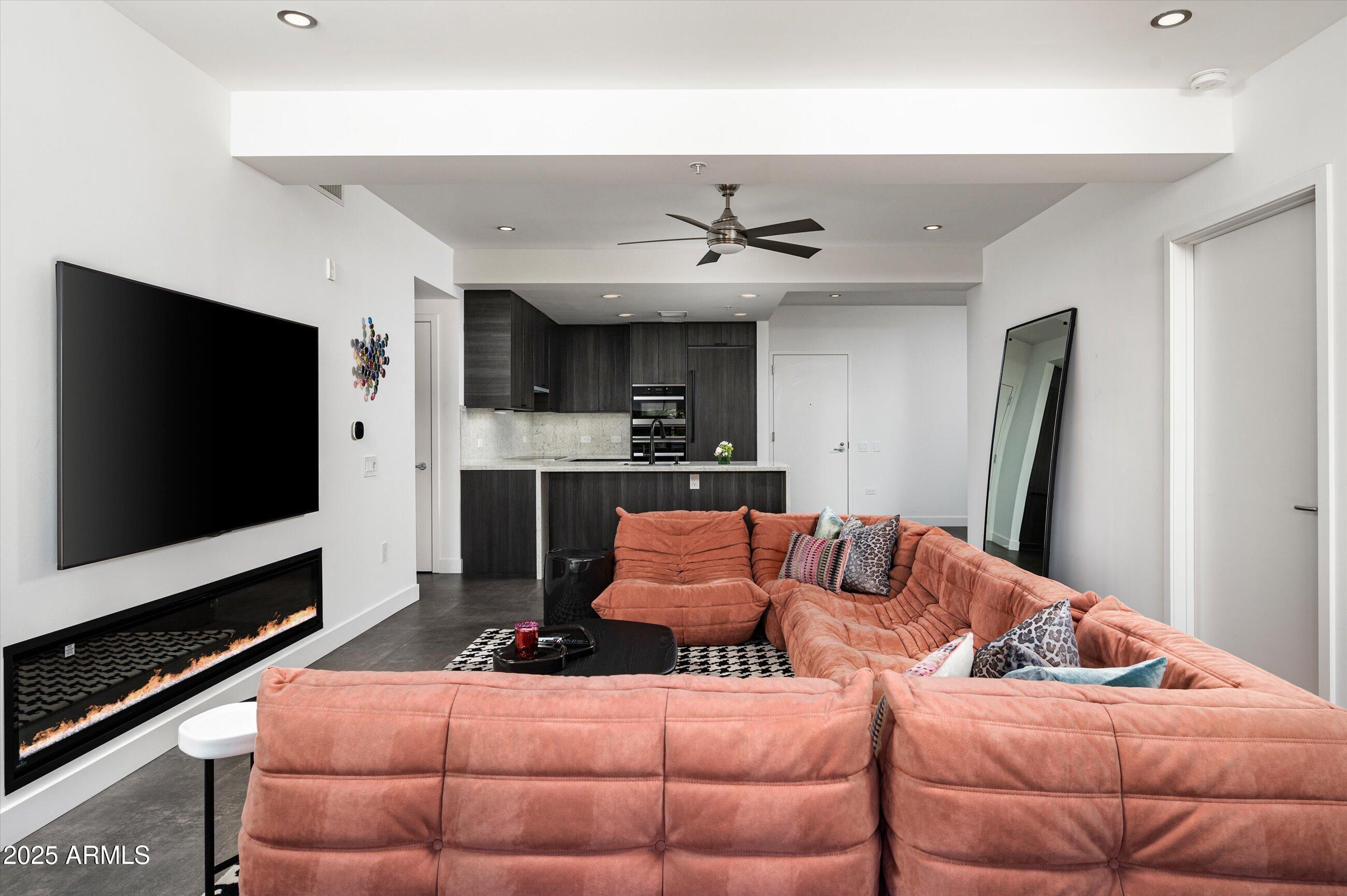7167 East Rancho Vista Drive, Unit 4010 Scottsdale, AZ 85251 - Photo 9 of 43 a living room with furniture and a flat screen tv