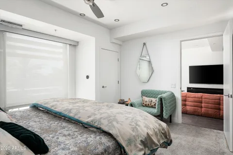 a bedroom with a bed and glass door