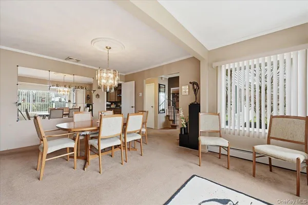 a dining room with furniture and window