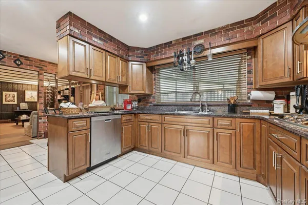 a kitchen with stainless steel appliances granite countertop a sink and cabinets