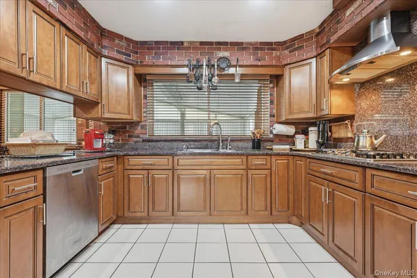 a kitchen with stainless steel appliances granite countertop a sink and cabinets