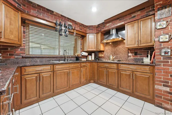 a kitchen with stainless steel appliances granite countertop a sink and cabinets