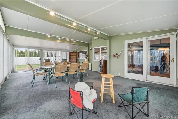a living room with lots of furniture and view of kitchen