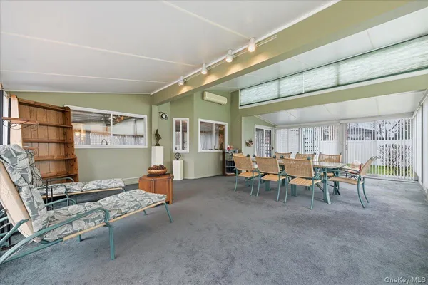 a living room with furniture a window and chairs